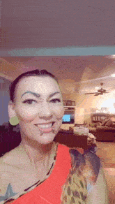 a woman with piercings on her nose and ears smiles for the camera