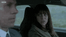 a man and a woman are sitting in a car with bbc written on the bottom of the screen