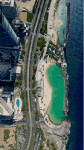 an aerial view of a beach with a large body of water in the foreground