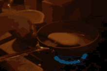 a frying pan is cooking on a gas stove