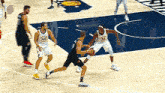 a group of basketball players are playing a game on a basketball court