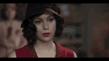 a group of women are standing next to each other in a room talking to each other .