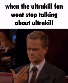 a man in a suit and tie is giving the middle finger to someone .