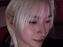 a close up of a person 's face with blonde hair .