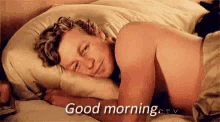 a man is sleeping in a bed with the words `` good morning '' written on the bottom .