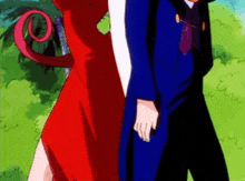 a man in a blue suit and a woman in a red dress are standing next to each other holding hands .
