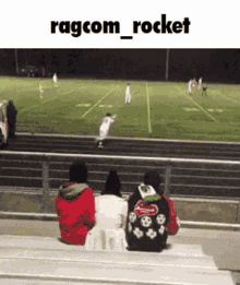a group of people sitting on bleachers watching a football game with ragcom_rocket written above them