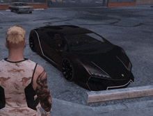 a man with a tattoo on his arm is standing next to a black car