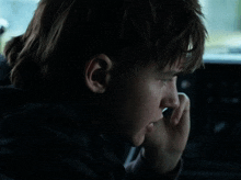a man is talking on a cell phone in a dark room
