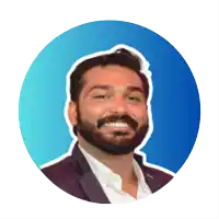 a man with a beard is smiling and wearing a suit