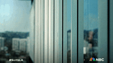 a nbc advertisement for suits la shows a building