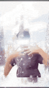 a person wearing a virtual reality headset is taking a picture of a snowy landscape .