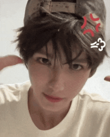 a person wearing a baseball cap and a white shirt is making a funny face .