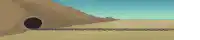 a blurred image of a tunnel in the desert with a blue sky in the background .