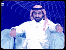 a man with a beard is sitting in a chair in front of a blue background that says do channels