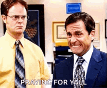 two men in suits and ties are standing next to each other and one of them is saying praying for yall .