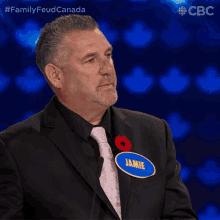 a man in a suit has a name tag that says jamie