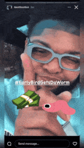 a man wearing glasses is holding a worm and a pile of money