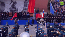 a group of soldiers marching in front of a crowd with the letters rt on the bottom of the screen