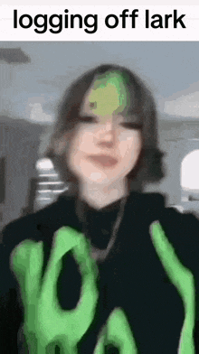 a blurry picture of a girl with green hair and the words `` logging off lark '' .