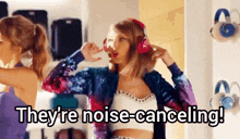 a woman wearing headphones says they are noise canceling