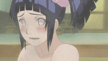 a girl with a flower in her hair is taking a bath with her eyes closed