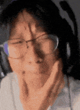 a close up of a person wearing glasses and a headset