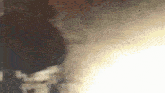 a close up of a person 's face with smoke coming out of their mouth .