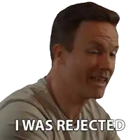 a man with a sticker that says i was rejected on his face