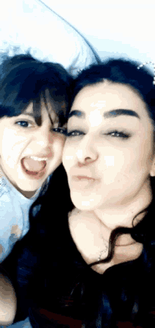 a woman and a little girl are posing for a photo