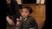 a little boy wearing a jacket that says ' abercrombie & fitch ' on the front