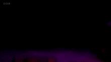 a dark room with a bbc logo on the bottom