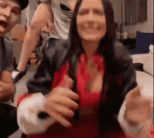 a woman in a red shirt is being held by a man in a room .
