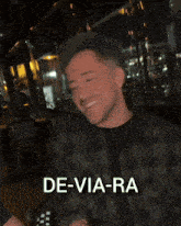 a man in a plaid shirt says de-via-ra on his face