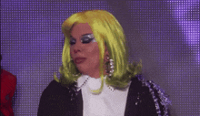 a woman in a green wig is standing in front of a purple background