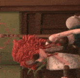 a cartoon character with red hair is holding a bottle of wine and a plant .