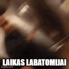 a close up of a person holding a knife with the words `` laika 's labatonijai '' written on it .