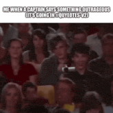 a crowd of people sitting in a theater with a caption that says me when a captain