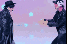 a man wearing a hat with the letter m on it is dancing with another man