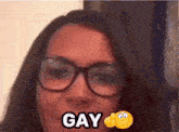 a woman wearing glasses and a smiley face with the word gay on it