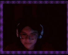 a blurry picture of a man wearing headphones in a dark room .
