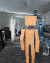 a cardboard robot is standing next to a water bottle