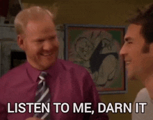a man in a purple shirt and tie is talking to another man who says listen to me darn it