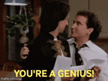 a man is holding another man in his arms and says you 're a genius