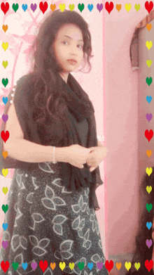 a woman in a black and white dress is surrounded by hearts