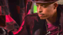 a man in a top hat is holding a deck of cards