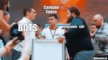 a group of men are standing in front of a sign that says cardano space bots chocolate cnt
