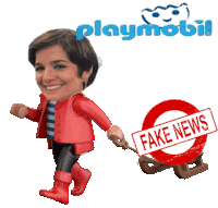 a playmobil doll is pulling a fake news sign