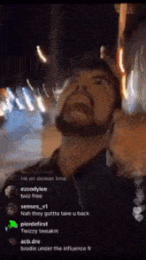 a man with a beard is wearing earbuds and screaming