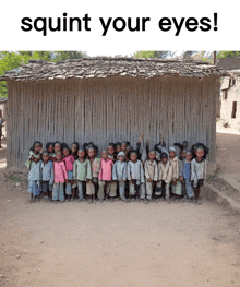 a group of children standing in front of a wooden building with the words squint your eyes below them
